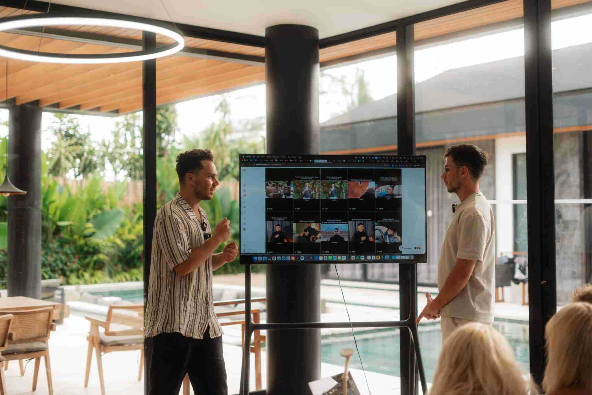 Sam teaching beside a screen of real work